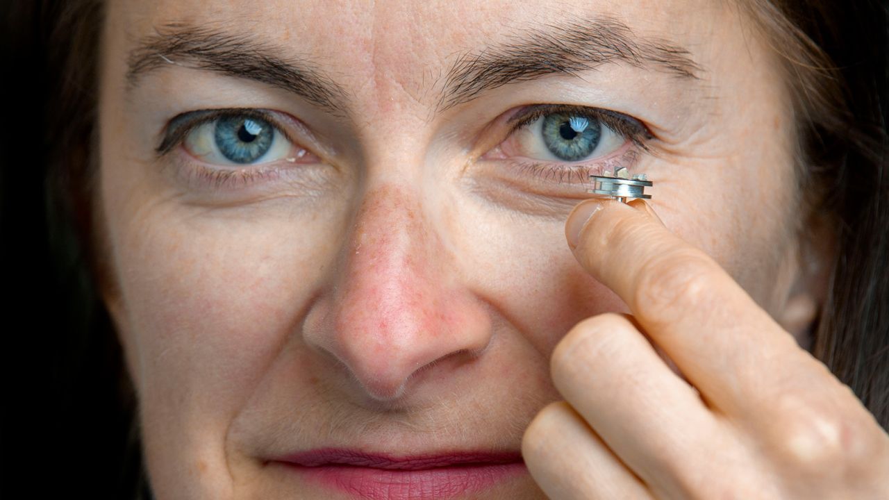 Maria McNamara holds a sample of the tiny pterosaur feathers.