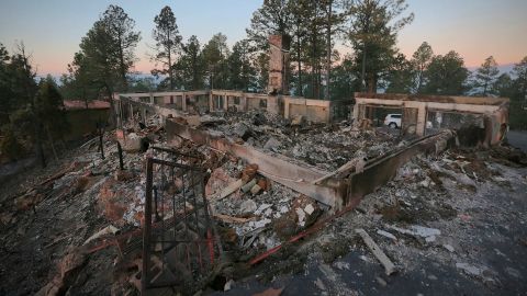 A house near Ruidoso, New Mexico, continues to smolder following the McBride Fire.