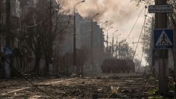 Armored personnel carriers of the so-called Donetsk People's Republic drive through a burning street in Mariupol on April 18.