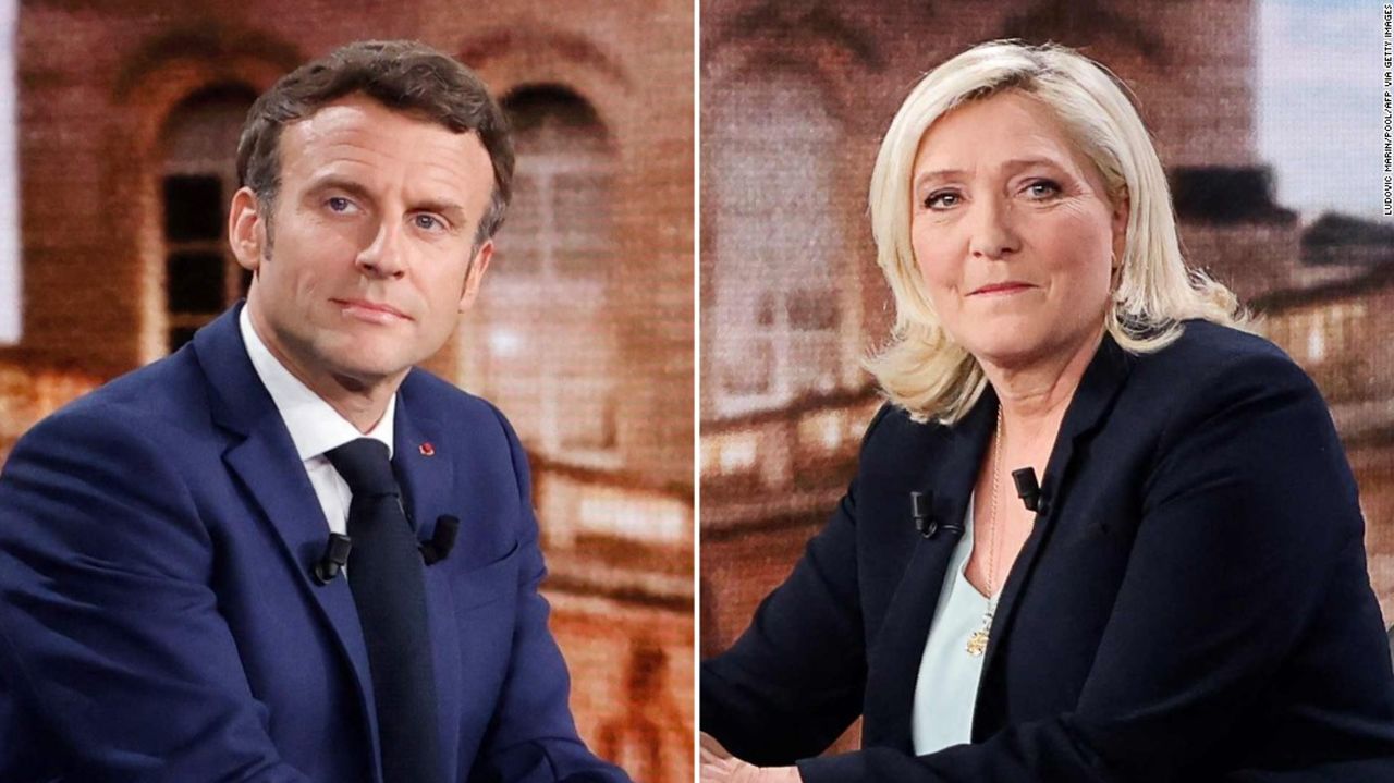 French President and La Republique en Marche (LREM) party candidate for re-election Emmanuel Macron (L) and French far-right party Rassemblement National (RN) presidential candidate Marine Le Pen (R) pose prior to taking part in a live televised debate on French TV channels TF1 and France 2 in Saint-Denis, north of Paris, ahead of the second round of France's presidential election. - French voters head to the polls for a run-off vote between Macron and Le Pen on April 24, 2022. (Photo by Ludovic MARIN / POOL / AFP) (Photo by LUDOVIC MARIN/POOL/AFP via Getty Images)