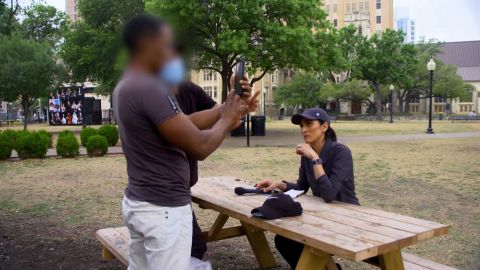 Joel attempts to use a government-issued phone to check in with ICE during an interview with CNN's Rosa Flores. CNN obscured part of this image to protect the subject's safety.