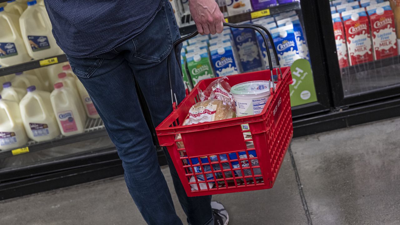 A customer holds a basket while shopping at a grocery store in San Francisco, California, U.S., on Thursday, Nov. 11, 2021. 