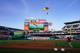 A member of the Army Golden Knights descends into Nationals Park before a baseball game between the Washington Nationals and the Arizona Diamondbacks on Wednesday, April 20, 2022.