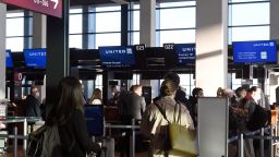 28 March 2022, Brandenburg, Schönefeld: Passengers wait at BER Airport in front of the United Airlines check-in counters. On flights to the U.S. East Coast, Berliners and Brandenburgers no longer necessarily have to change planes. From Monday, United Airlines will be connecting Schönefeld directly with New York's Newark Airport on a daily basis. This is the first long-haul connection from BER to the USA. Photo: Bernd Settnik/dpa-Zentralbild/dpa (Photo by Bernd Settnik/picture alliance via Getty Images)