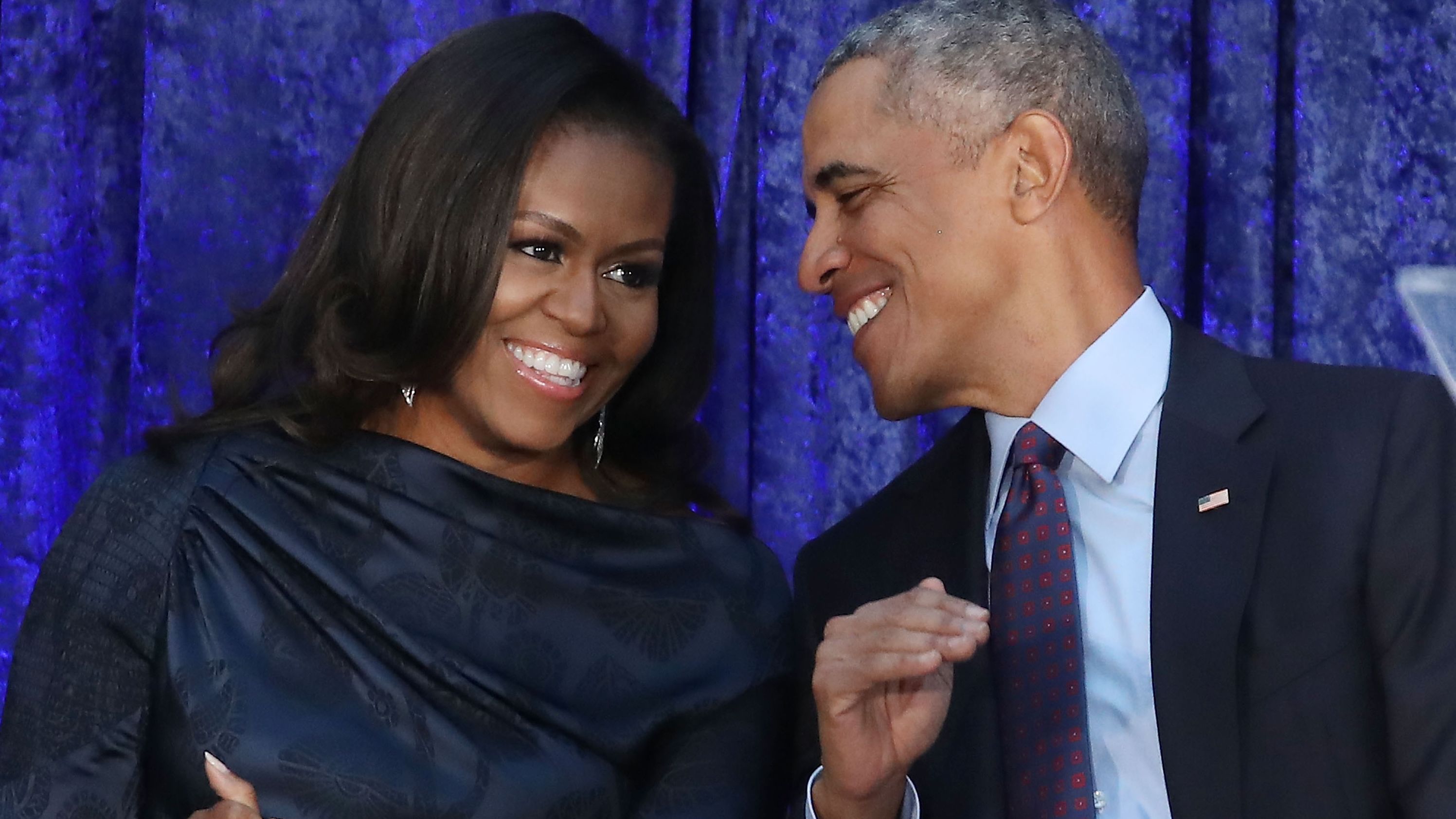 Former U.S. President Barack Obama and first lady Michelle Obama participate in the unveiling of their official portraits during a ceremony at the Smithsonian's National Portrait Gallery, on February 12, 2018 in Washington, DC. The portraits were commissioned by the Gallery, for Kehinde Wiley to create President Obama's portrait, and Amy Sherald that of Michelle Obama. 