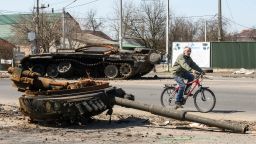 A man ride bike near Destroyed Russian military tank near Brovary, Kyiv area, Ukraine, 15 April 2022 