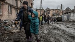 Civilians walk through a destroyed neighborhood in Eastern Mariupol that has recently come under control of Russia/ pro-Russian forces. The battle between Russian / Pro Russian forces and the defending Ukrainian forces led by the Azov battalion continues in the port city of Mariupol.