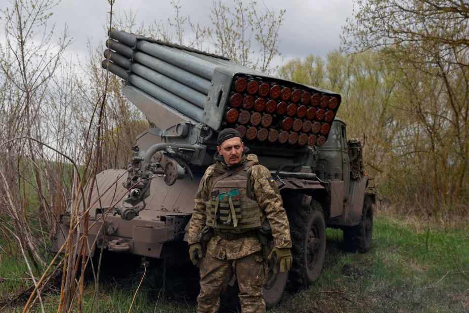 A Ukrainian serviceman stands next to a multiple rocket-launch system in the Kharkiv region of Ukraine on April 20.