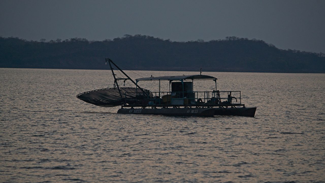 A fishing rig sails into the waters of Lake Kariba on 03 November 2021. Successive droughts have caused the kapenta fishing business to become less lucrative as there are too many rigs on the ever decreasing water body.