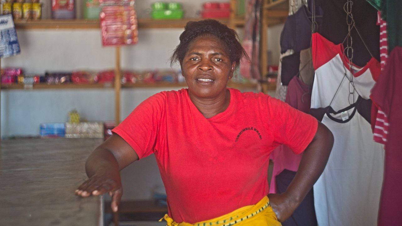 Mercy Mwinde, a member of the women's fishing cooperative poses for a portrait in her grocery store at Siachilaba centre on 04, November 2021. Mwinde built and started the business with proceeds from the fishing project.