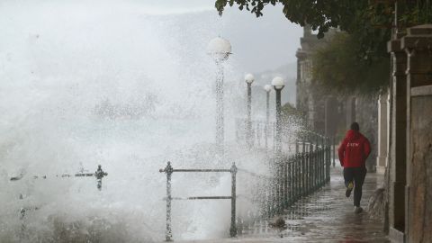 A man runs away from waves in Volosko, Croatia, on October 29, 2018.