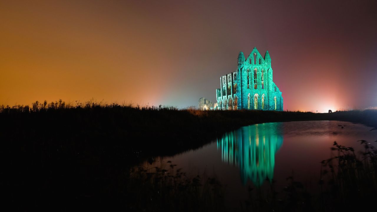 WHITBY, ENGLAND - OCTOBER 27: A spectacular light display illuminates the historic Whitby Abbey on October 27, 2015 in Whitby, England. The famous Benedictine abbey will be illuminated over four nights to coincide with Halloween and the popular Whitby Goth Weekend. The Abbey was part of the inspiration for Bram Stoker's novel, Dracula, and sits on East Cliff in the town in a commanding position overlooking the North Sea. (Photo by Ian Forsyth/Getty Images)