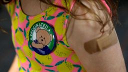 A child wears a pin she received after receiving her first dose of the Pfizer Covid-19 vaccine at the Beaumont Health offices in Southfield, Michigan on November 5, 2021. (Photo by JEFF KOWALSKY / AFP) (Photo by JEFF KOWALSKY/AFP via Getty Images)