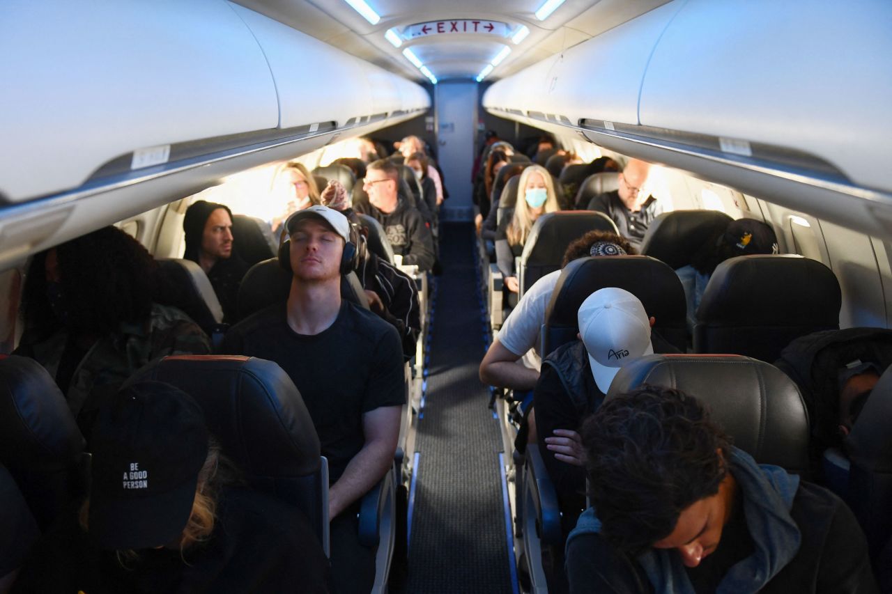 Passengers, some wearing face masks and some not, travel on an American Airlines flight from Los Angeles to Denver on Tuesday, April 19. It was the day after the federal mask mandate <a href="https://www.cnn.com/2022/04/18/politics/cdc-mask-mandate-ruling/index.html" target="_blank">was struck down by a federal judge.</a>