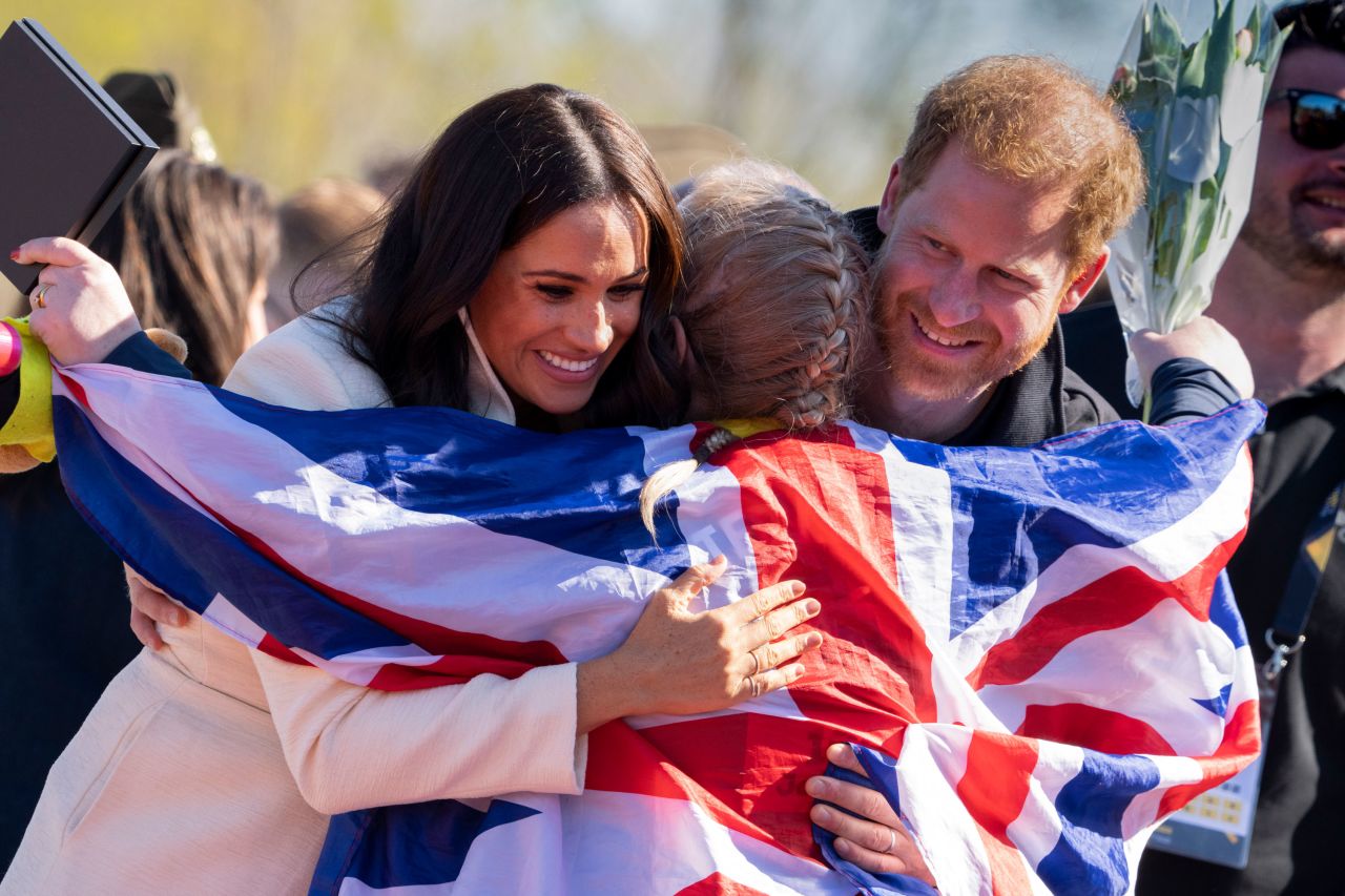 Britain's Prince Harry and his wife Meghan, the Duchess of Sussex, hug Lisa Johnston, a former army medic who won a medal at the Invictus Games in The Hague, Netherlands, on Sunday, April 17. Prince Harry founded the Invictus Games, which is a sporting competition for service members and veterans who have been wounded, injured or sick.