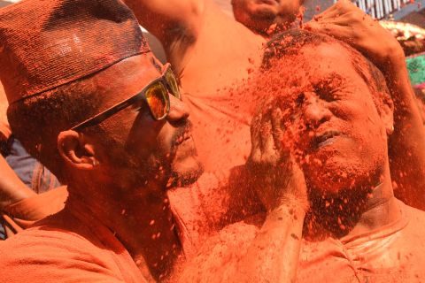 Revelers smeared in vermilion powder take part in the Bisket Jatra festival in Thimi, Nepal, on Friday, April 15. The festival marks the start of the Nepali New Year.