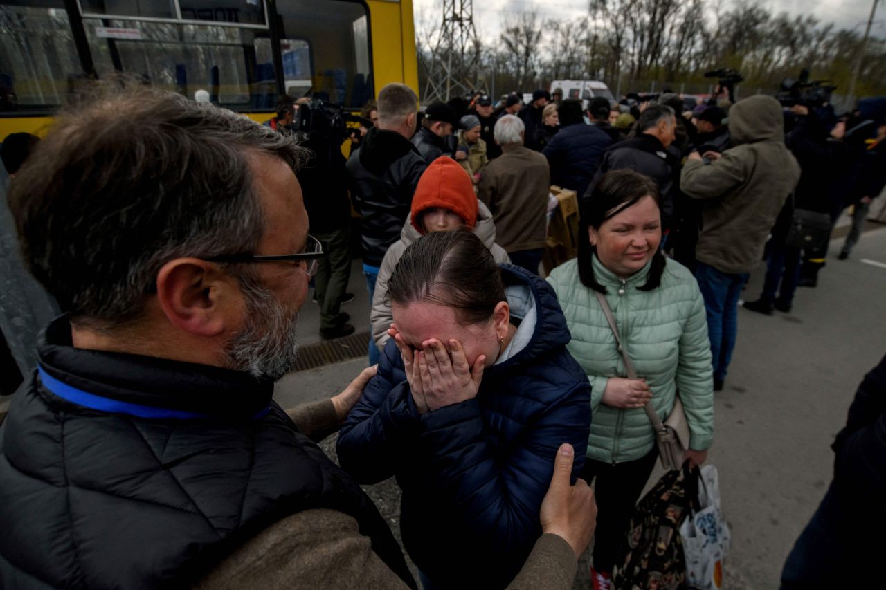 People who fled Mariupol, Ukraine, meet with relatives and friends as they arrive at a registration center for internally displaced people in Zaporizhzhia, Ukraine, on Thursday, April 21.