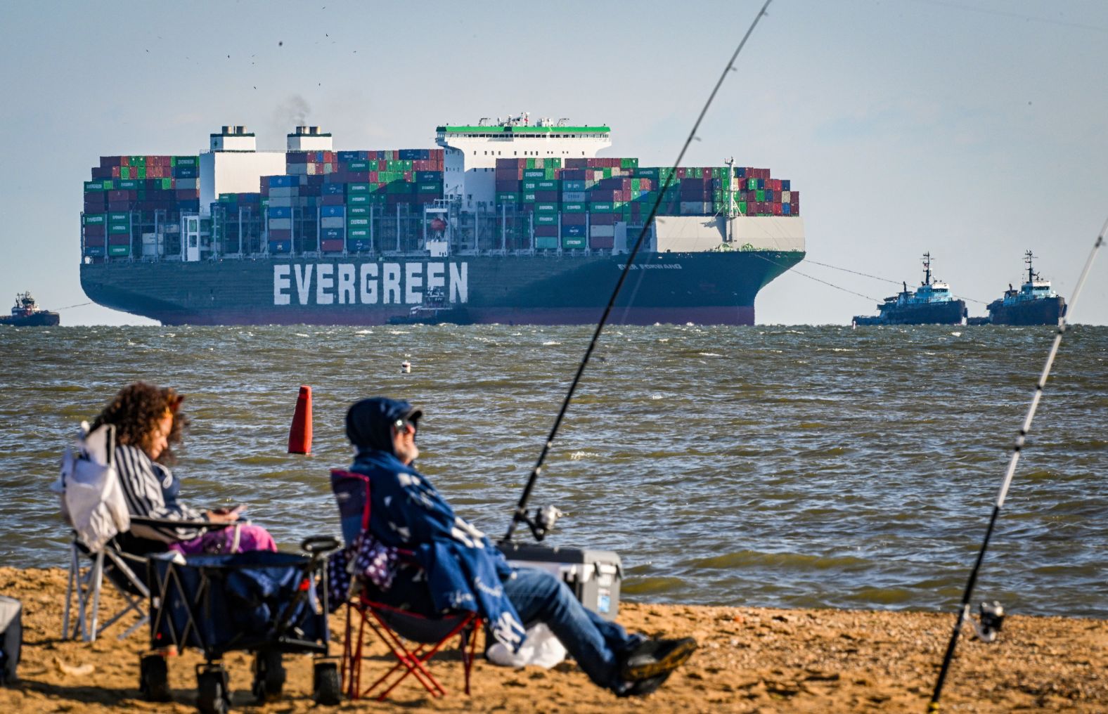 Michelle Micheals and Robert Fenstermacher fish in Sandy Point, Maryland, as the Ever Forward container ship approaches the Chesapeake Bay Bridge on Sunday, April 17. The ship was freed that day after <a href="index.php?page=&url=https%3A%2F%2Fwww.cnn.com%2F2022%2F04%2F18%2Fus%2Fevergreen-container-ship-chesapeake-bay%2Findex.html" target="_blank">it had been stuck in the bay for a month.</a>