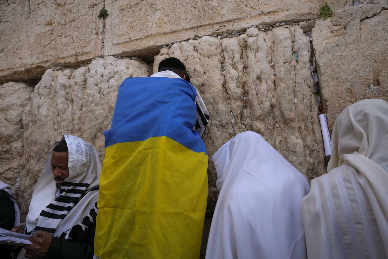 An ultra-Orthodox Jewish man wrapped in a Ukrainian flag visits the Western Wall in Jerusalem during the Passover holiday on Monday, April 18.