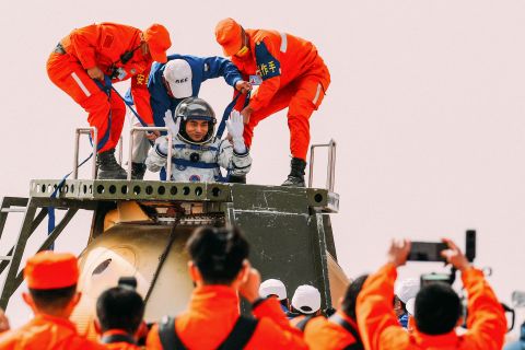 Chinese astronaut Ye Guangfu is helped out of his spacecraft's capsule after landing in China's Inner Mongolia region on Saturday, April 16. Three Chinese astronauts returned to Earth after spending six months on the country's new space station.
