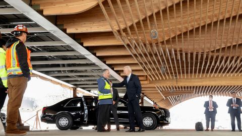 President Joe Biden speaks to a worker as he views a new roof under construction at Portland International Airport in Oregon on April 21, 2022. 