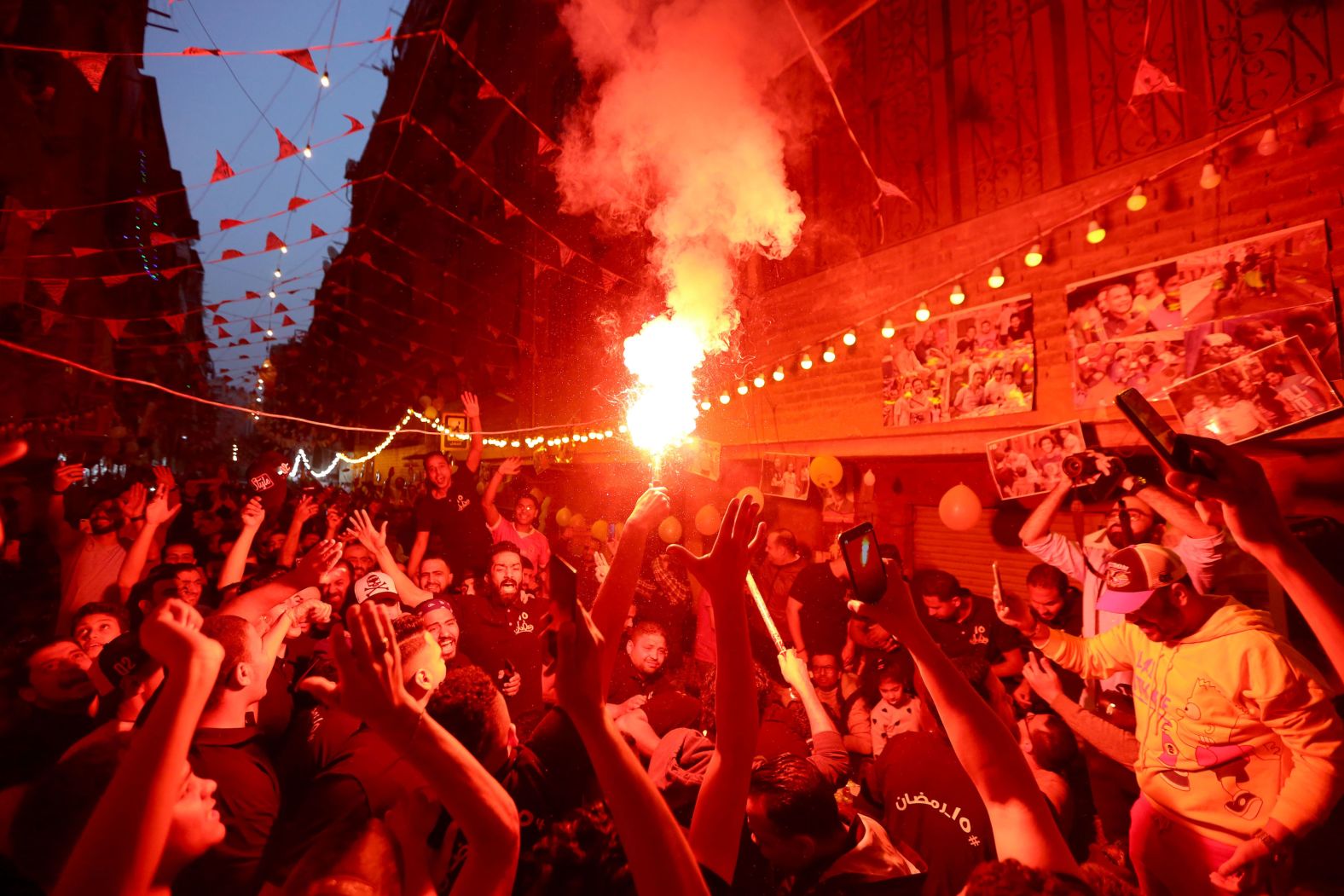 People in Cairo celebrate with fireworks during a mass iftar gathering in Cairo on Saturday, April 16. During the Muslim holy month of Ramadan, iftar is the breaking of fast after sundown.