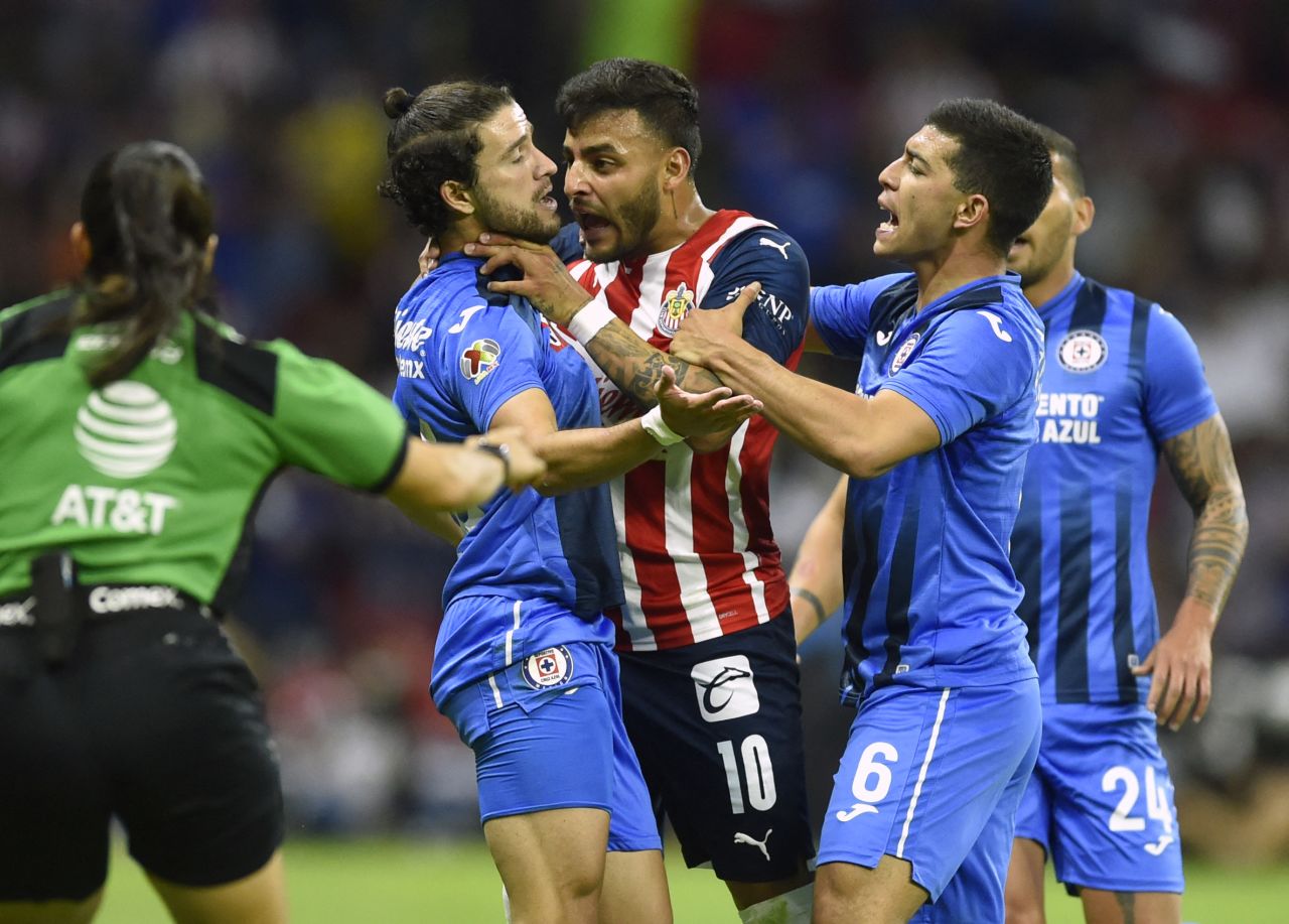 Guadalajara soccer player Alexis Vega tries to choke Cruz Azul's Ignacio Rivero during a match in Mexico City on Saturday, April 16. Vega received a red card.