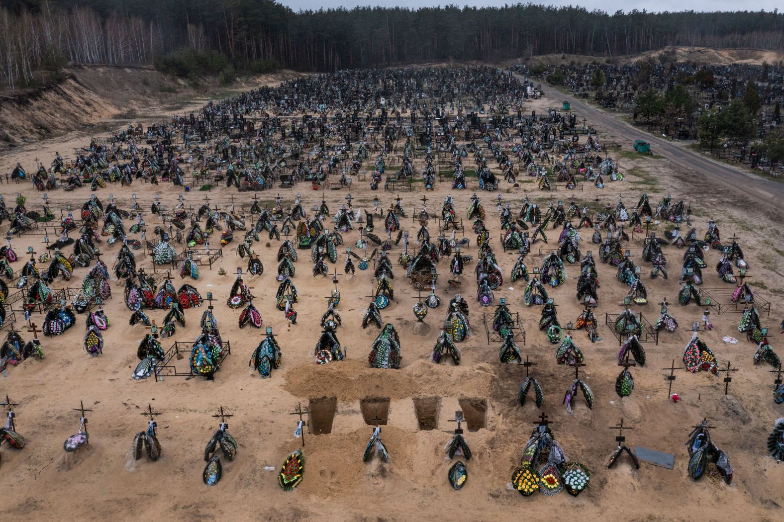 Four freshly dug graves are seen at a cemetery in Irpin, Ukraine, on Saturday, April 16.