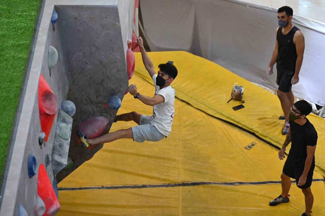 Bouldering is performed without ropes. Here, a man practices at a Jakarta, Indonesia, mall.