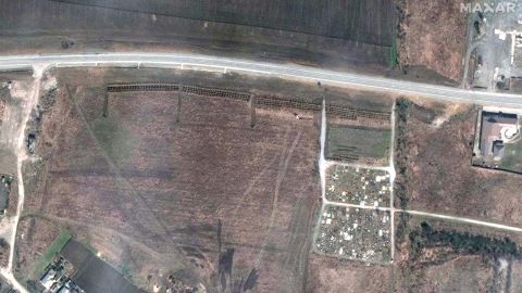 A satellite image from  April 3 shows what appears to be a newly dug mass grave site, next to the cemetery. 