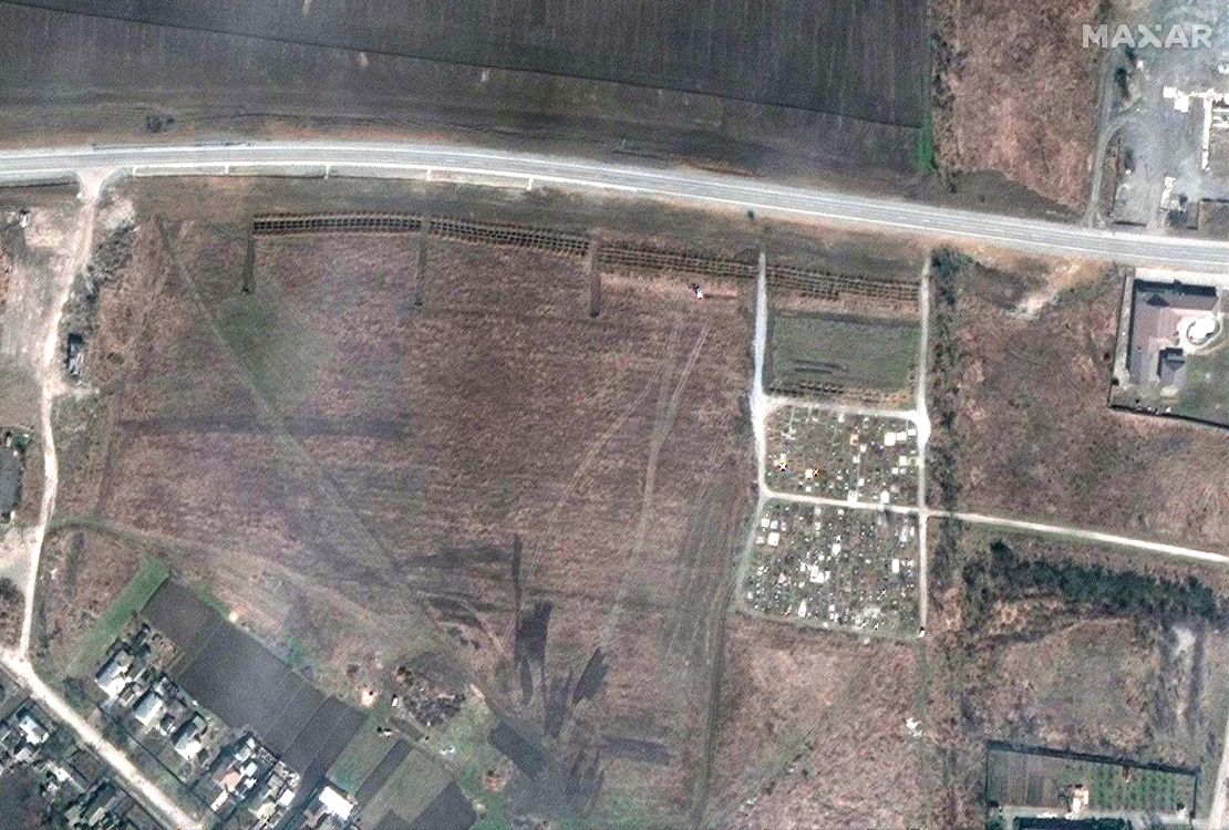 A satellite image from April 3 shows what appears to be a newly dug mass grave site, next to the cemetery.
