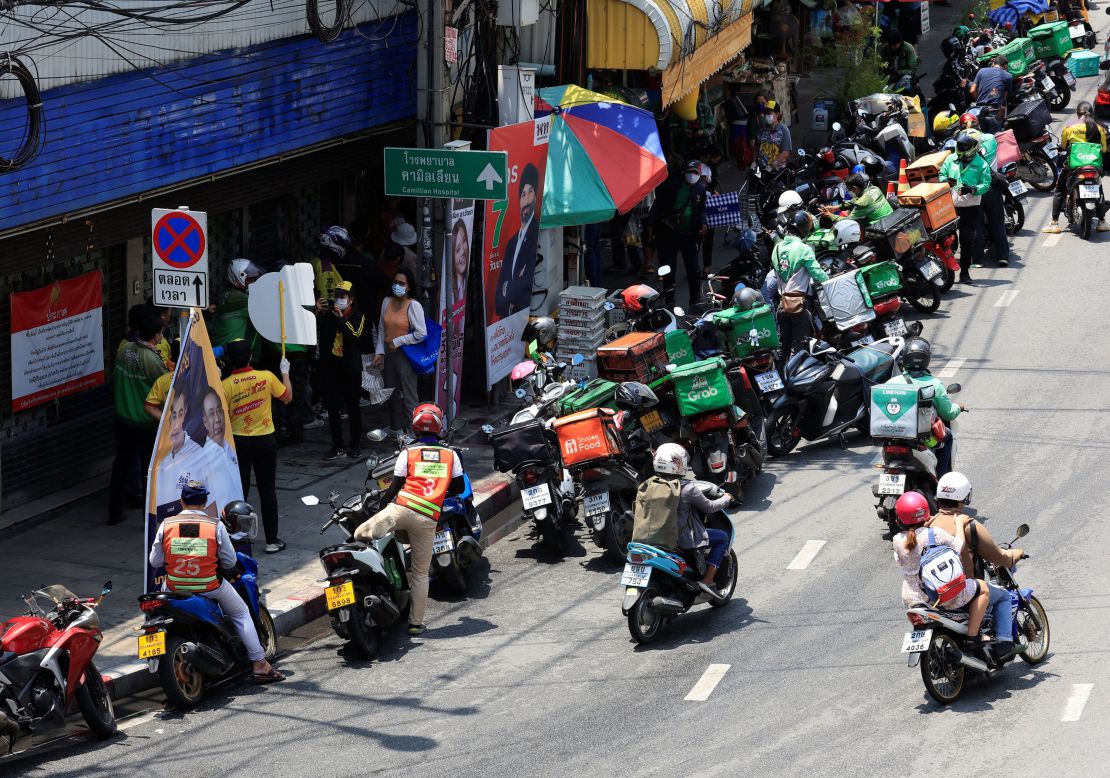 Delivery bikers line up at a mango sticky rice shop in Bangkok on April 21, 2022.  