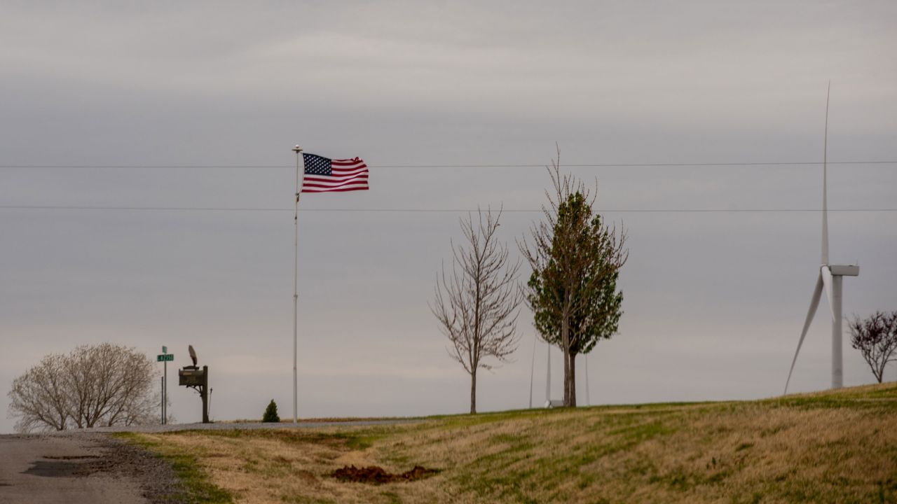The wind whips at an American flag.