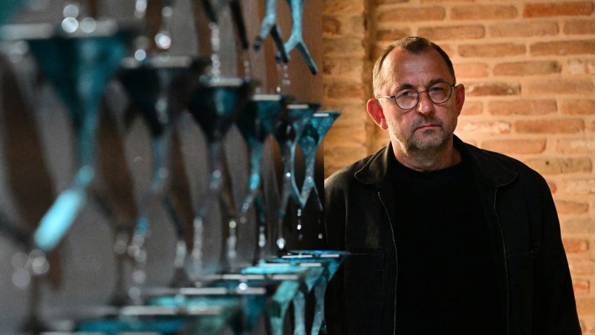 Ukrainian artist Pavlo Makov poses by his piece 'Fountain of Exhaustion' at Ukraine's pavilion during a press day at the 59th Venice Art Biennale in Venice on April 19, 2022. - Eighty countries, including Ukraine, will have a pavilion at the 59th Biennale, which is set to begin on April 23 and runs through November. - RESTRICTED TO EDITORIAL USE - MANDATORY MENTION OF THE ARTIST UPON PUBLICATION - TO ILLUSTRATE THE EVENT AS SPECIFIED IN THE CAPTION (Photo by Vincenzo PINTO / AFP) / RESTRICTED TO EDITORIAL USE - MANDATORY MENTION OF THE ARTIST UPON PUBLICATION - TO ILLUSTRATE THE EVENT AS SPECIFIED IN THE CAPTION / RESTRICTED TO EDITORIAL USE - MANDATORY MENTION OF THE ARTIST UPON PUBLICATION - TO ILLUSTRATE THE EVENT AS SPECIFIED IN THE CAPTION (Photo by VINCENZO PINTO/AFP via Getty Images)