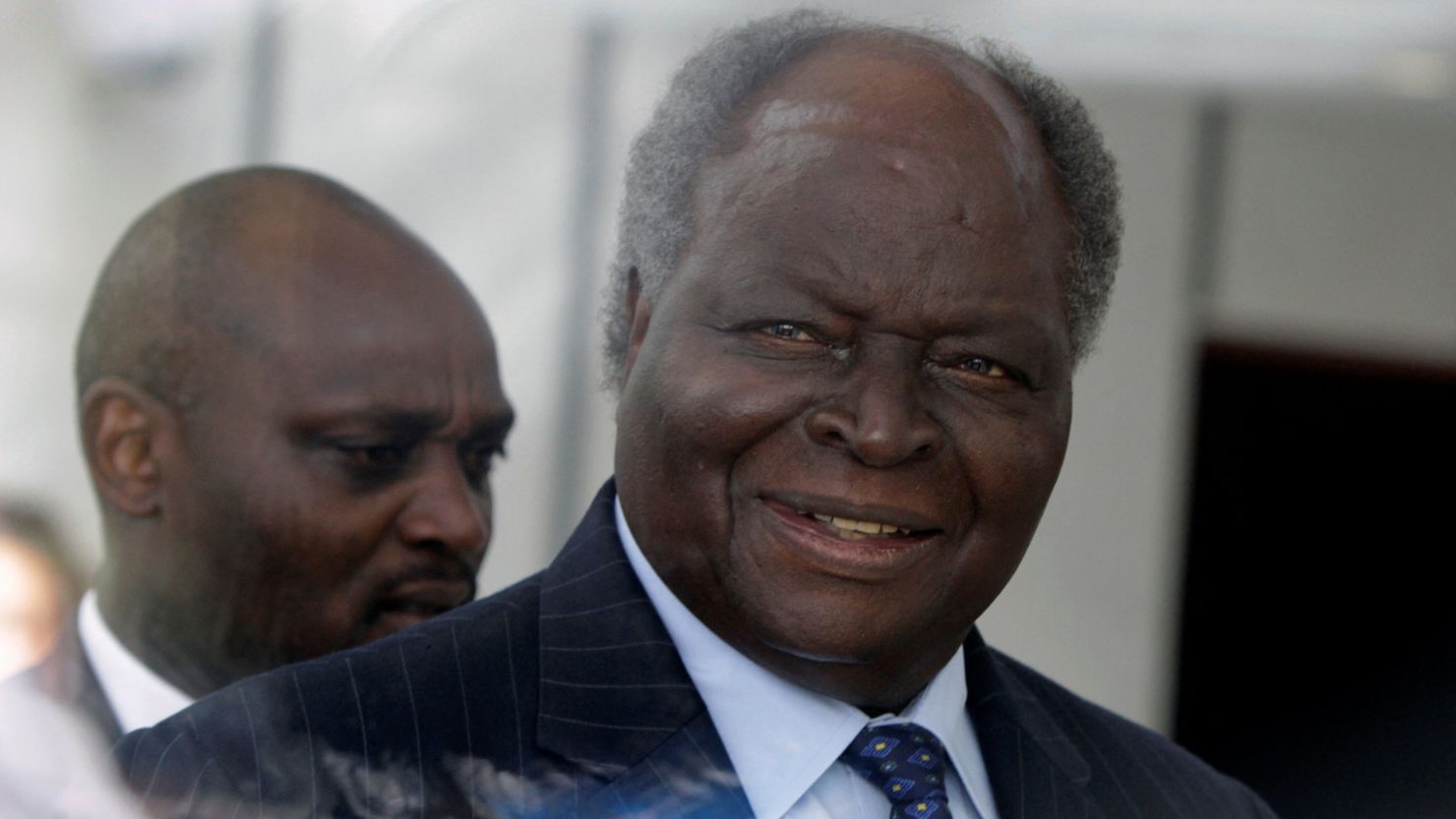 Kenya's President Mwai Kibaki is seen walking behind a glass wall as he arrives for the inauguration of the new African Union building in Ethiopia's capital Addis Ababa, on January 28, 2012.