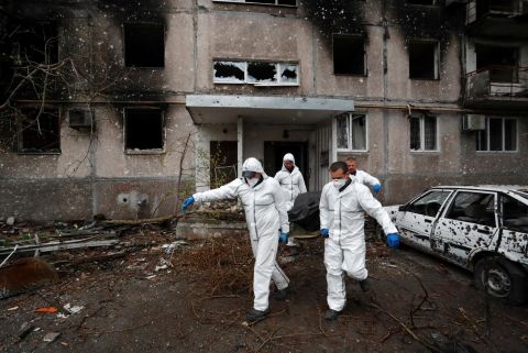 Emergency workers remove the body of a person killed during the Russian attack on Mariupol.