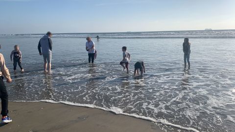 Merridith Cho says this Ukrainian family was exhausted and shaken when they arrived in the US. But after sleeping for a few hours at Cho's home, their families went to the beach together. "We realized they'd never seen the ocean. ... It was just an amazing reprieve for a little while from their reality," she says. CNN has blurred portions of this image to protect the Ukrainian family's identity.