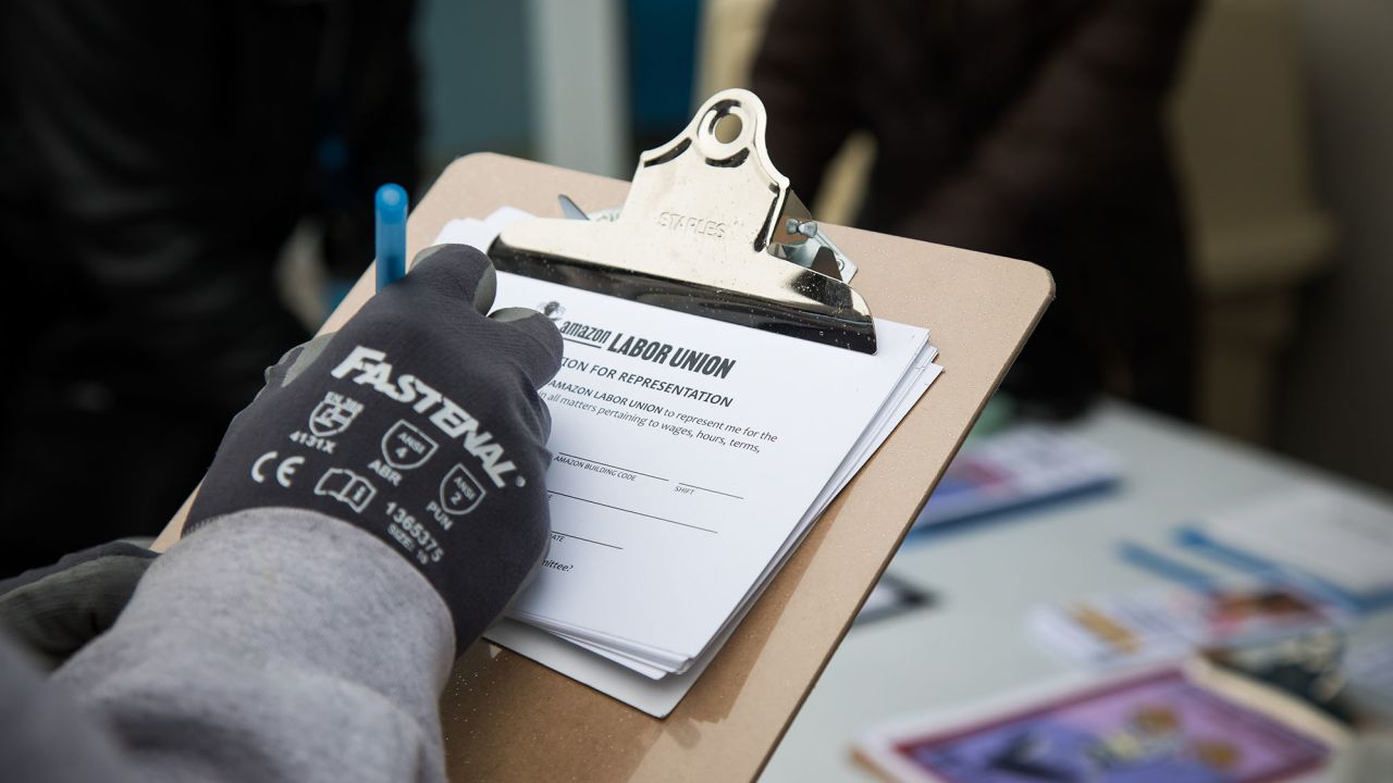An Amazon employee signs a labor union authorization for representation form outside the Amazon LDJ5 fulfillment center in the Staten Island borough of New York, on Monday, Feb. 7, 2022.