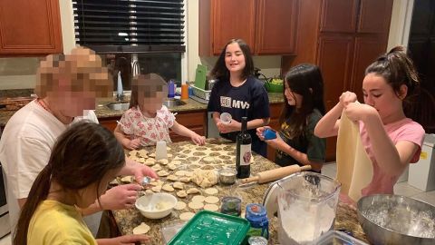 Merridith Cho says her daughters were excited to learn to make pierogis from one of the Ukrainian families who stayed with them. She says it was one of many beautiful moments of connection. CNN has blurred portions of this image to protect the Ukrainian family's identity.
