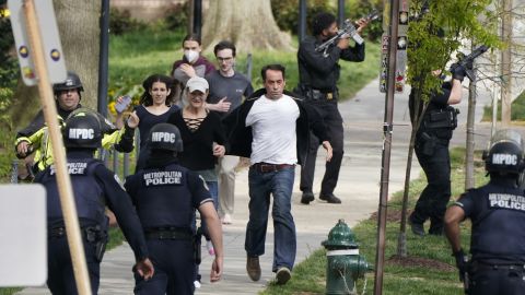 Police evacuate people near the scene of the shooting.