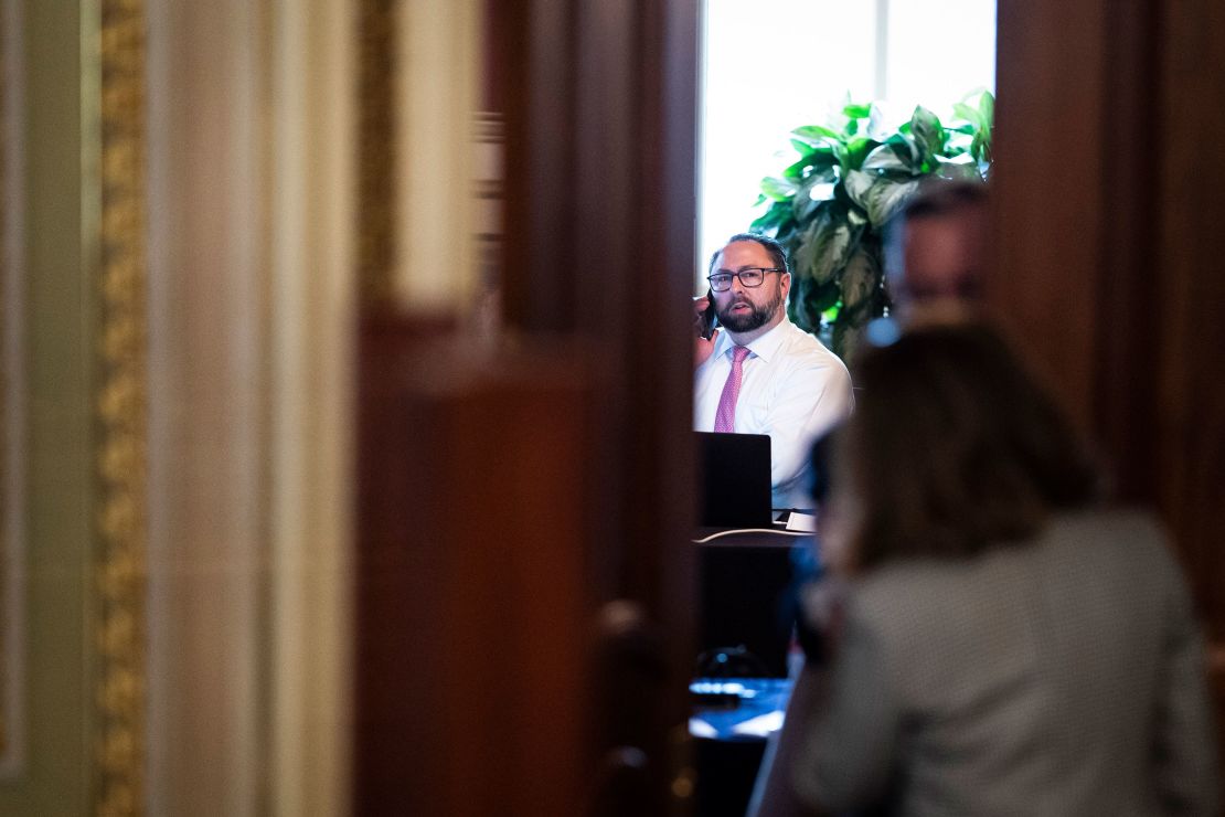 Jason Miller talks on the phone in a meeting room for lawyers of former President Donald Trump during his Senate Impeachment trial on Capitol Hill, February 12, 2021