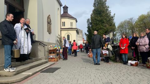 A priest reminds parishioners of Jesus' sacrifice from the steps of the Church of the Intercession of the Blessed Virgin in Lviv, Ukraine on April 23, 2022.