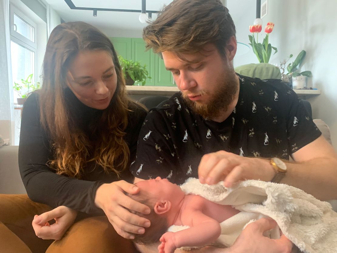Anna-Mariia Nykyforchyn, left, and husband Nazar, right, gaze at their month-old daughter, Marharyta.