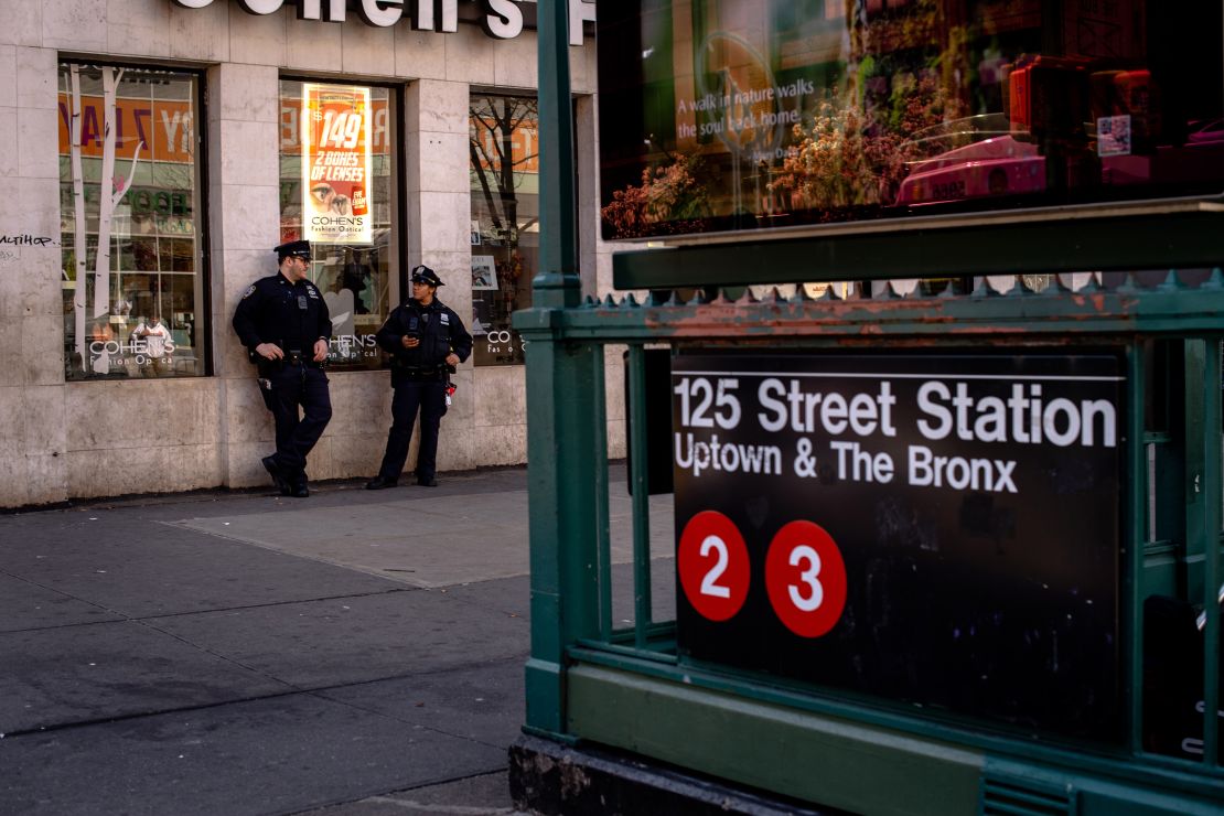 Police officers stand outside of Harlem's 125 Street Station.