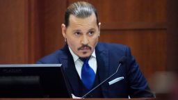 Actor Johnny Depp sits to testify in the courtroom at the Fairfax County Circuit Courthouse in Fairfax, Virginia, April 25, 2022. - Actor Johnny Depp sued his ex-wife Amber Heard for libel in Fairfax County Circuit Court after she wrote an op-ed piece in The Washington Post in 2018 referring to herself as a "public figure representing domestic abuse." (Photo by Steve Helber / POOL / AFP) (Photo by STEVE HELBER/POOL/AFP via Getty Images)