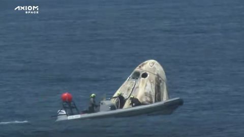 Recovery crews approach the Crew Dragon capsule after splashdown.