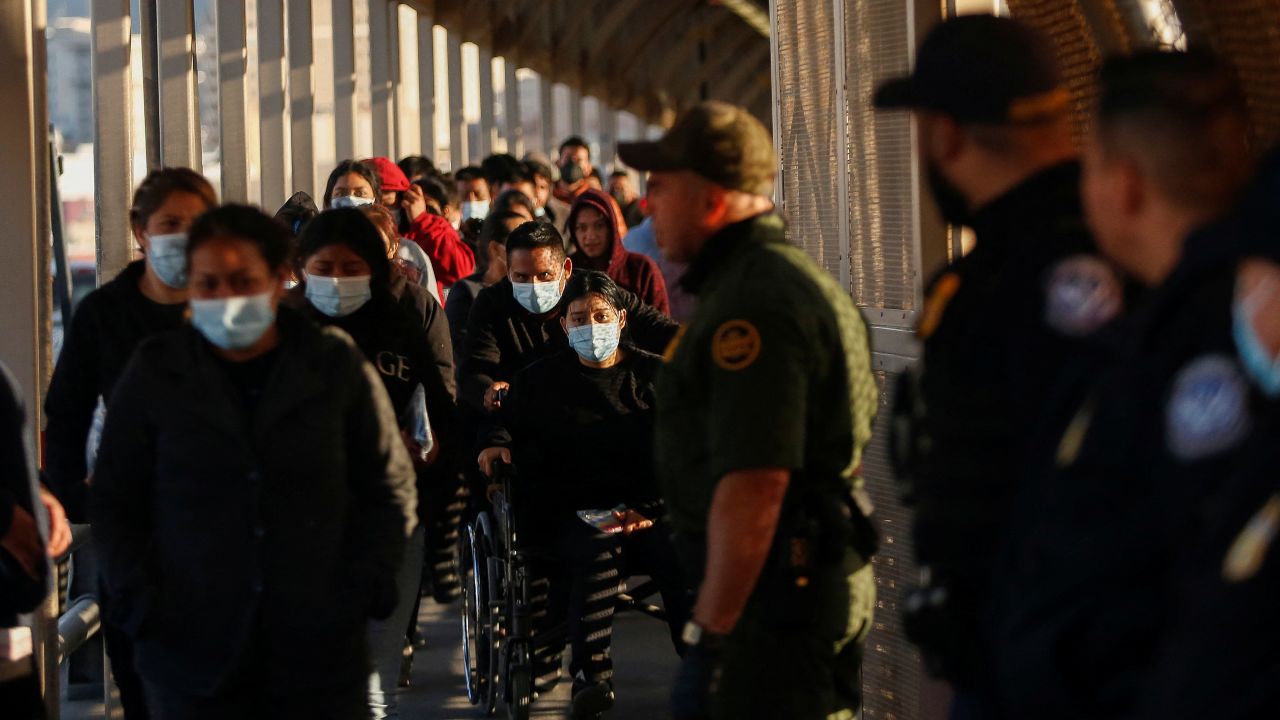 Migrants expelled from the US and sent back to Mexico under Title 42, walk toward Mexico at the Paso del Norte International border bridge, in this picture taken from Ciudad Juarez, Mexico on April 1, 2022. 