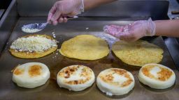 A cook prepares arepas in the kitchen of the Arepa Lady restaurant in the Queens borough of New York City on January 27, 2022.