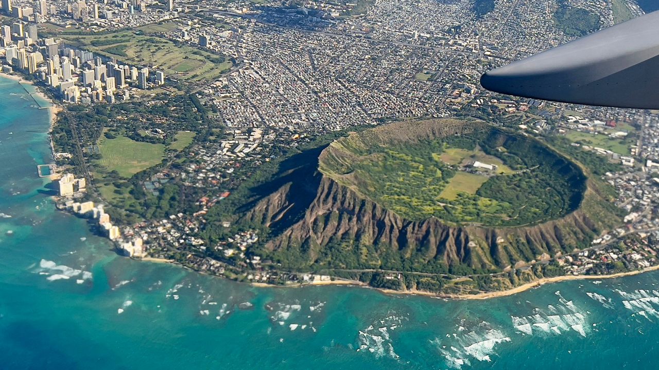 An aerial view from the window of a plane shows Diamond Head crater in Oahu, Hawaii on February 23, 2022. (Photo by Daniel SLIM / AFP) (Photo by DANIEL SLIM/AFP via Getty Images)