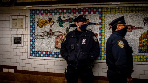 Police officers standing inside the Harlem 125 Street Station.
